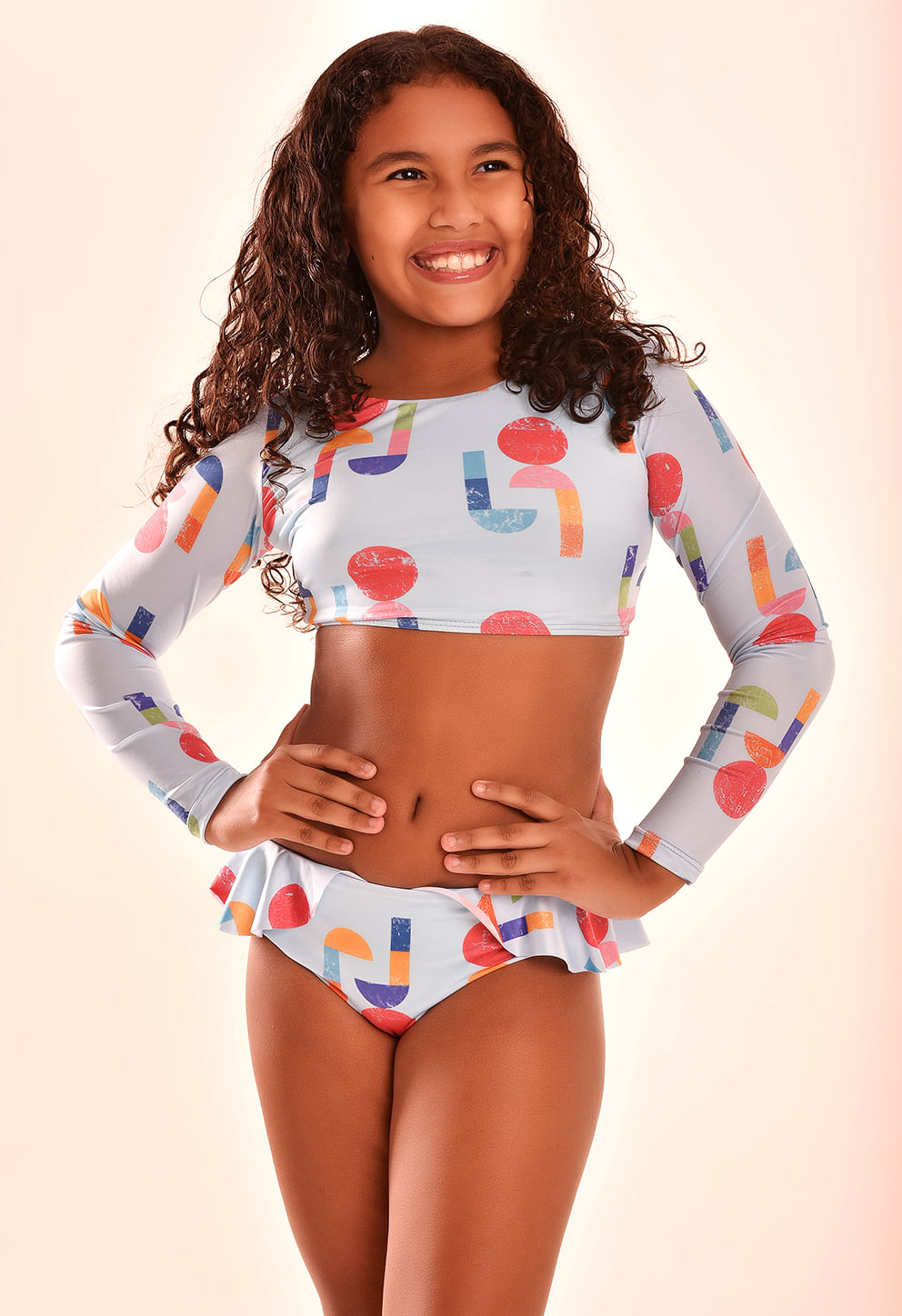 Menina sorridente usando biquíni infantil Dora Pac Man com estampa colorida