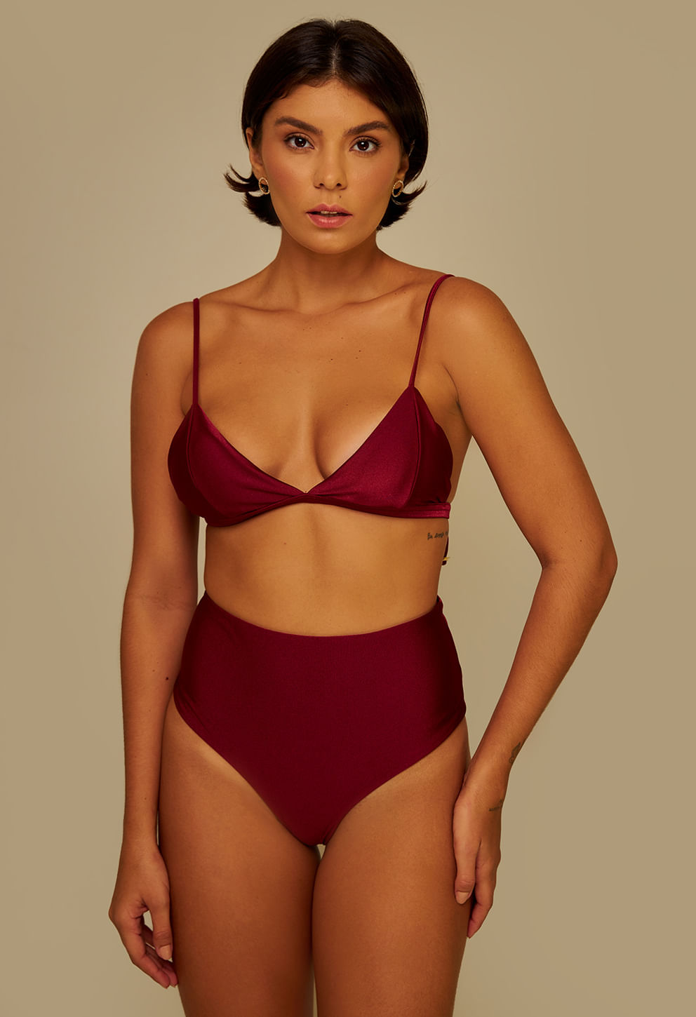 Imagem frontal de modelo usando biquíni vinho com calcinha hot pant de cintura alta em tecido acetinado