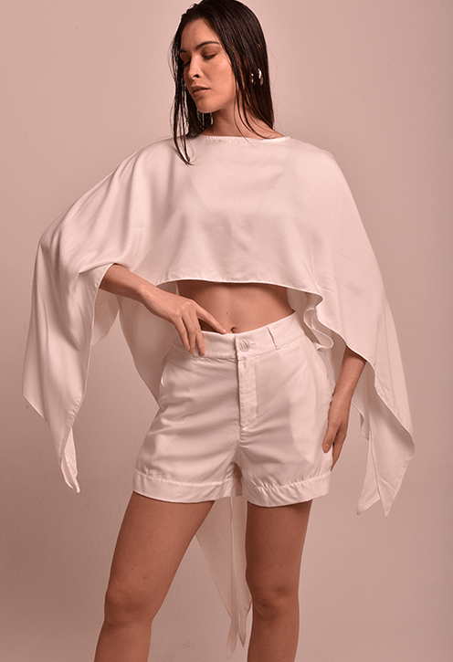 Modelo de perfil usando Blusa Lane Alvorada Off, cropped com mangas largas e laterais alongadas