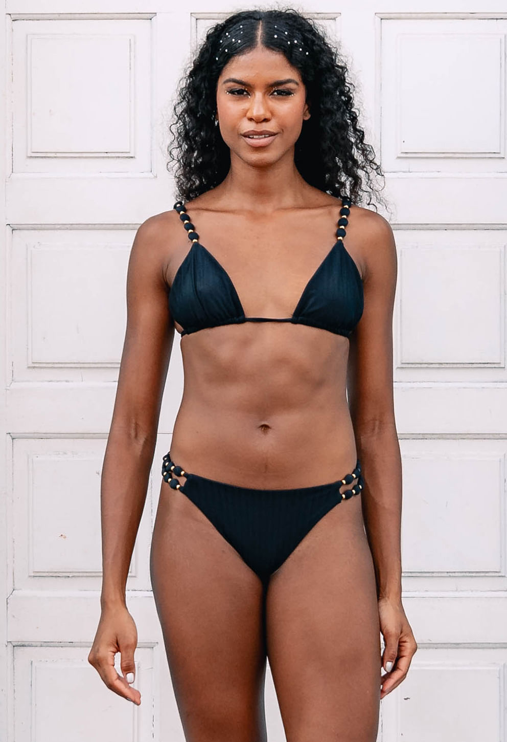 Mulher negra usando Top Jaque Xodó preto cortininha com alças e detalhes dourados